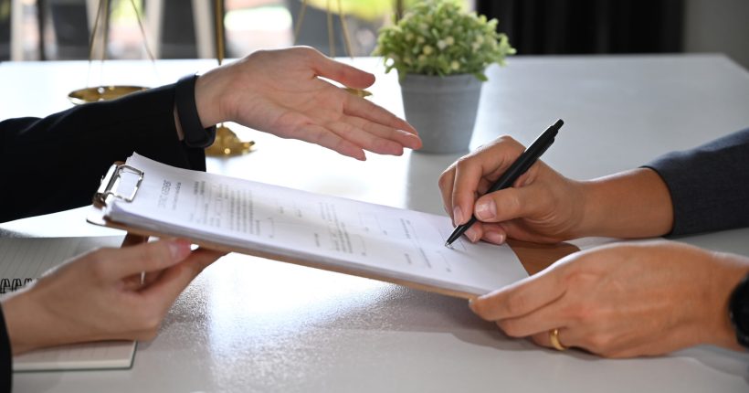 Cropped imaged of female lawyer discussing contract document, providing law consultation and legal advice to her client.